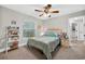 Cozy bedroom with plush carpeting, natural light from a window, and decorative items at 8160 Se 164Th Pl, Summerfield, FL 34491