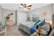 Charming bedroom featuring comfortable bed, ceiling fan and colorful decor at 8160 Se 164Th Pl, Summerfield, FL 34491