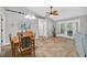 Bright dining area with modern furnishings, large windows, and seamless access to outdoor views at 8160 Se 164Th Pl, Summerfield, FL 34491