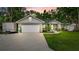 Charming home featuring a spacious driveway, landscaped yard, and inviting entryway at 8160 Se 164Th Pl, Summerfield, FL 34491
