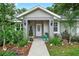 Inviting front entrance with elegant landscaping, decorative lighting, and a stylish front door at 8160 Se 164Th Pl, Summerfield, FL 34491