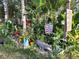 Tropical themed garden features an alligator statue, flip flops, and tiki decorations at 8160 Se 164Th Pl, Summerfield, FL 34491