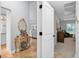 Charming hallway with decorative table, archway leading to the living room, and doorway to the main bedroom at 8160 Se 164Th Pl, Summerfield, FL 34491