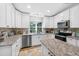 Updated kitchen features stainless appliances, granite countertops, and ample cabinet space at 8160 Se 164Th Pl, Summerfield, FL 34491