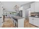 Bright kitchen with stainless steel appliances, granite counters and an island with seating at 8160 Se 164Th Pl, Summerfield, FL 34491