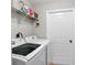 Laundry room featuring white washer and dryer with wire rack and white door at 8160 Se 164Th Pl, Summerfield, FL 34491