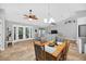 Open-concept living room featuring tiled flooring, ceiling fans, comfortable seating, and natural light streaming through French doors at 8160 Se 164Th Pl, Summerfield, FL 34491