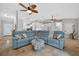 Open concept living room offering tile flooring, multiple ceiling fans, and generous natural light at 8160 Se 164Th Pl, Summerfield, FL 34491