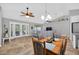 Combined open concept living space featuring dining area, sun room access, and tile flooring at 8160 Se 164Th Pl, Summerfield, FL 34491