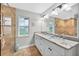 Well-lit bathroom with spacious tiled shower, dual sinks and granite countertops at 8160 Se 164Th Pl, Summerfield, FL 34491