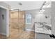 Elegant bathroom with walk-in shower, double sinks with marble countertops, and neutral color palette at 8160 Se 164Th Pl, Summerfield, FL 34491