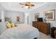Spacious bedroom featuring cozy bed with decorative pillows, wooden dresser and carpeted floor at 8160 Se 164Th Pl, Summerfield, FL 34491