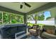Relaxing patio area with hot tub, comfortable seating, and a view of the backyard at 8160 Se 164Th Pl, Summerfield, FL 34491