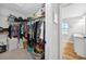 Walk-in closet with ample shelving and storage, leading to the main bathroom at 8160 Se 164Th Pl, Summerfield, FL 34491
