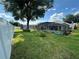 Expansive backyard view showcasing the screened pool area and lush landscaping at 15509 Markham Dr, Clermont, FL 34714