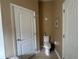 This powder room features a toilet and tile floors at 15509 Markham Dr, Clermont, FL 34714