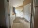 Bathroom features a double sink vanity with white cabinets, a tub, and tile floors at 15509 Markham Dr, Clermont, FL 34714
