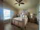 Bedroom features a ceiling fan and a view of the backyard at 15509 Markham Dr, Clermont, FL 34714