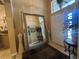 Foyer with tile flooring, a large mirror, and a front door with sidelight windows at 15509 Markham Dr, Clermont, FL 34714