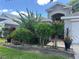 Home exterior with mature landscaping and a covered front entrance at 15509 Markham Dr, Clermont, FL 34714