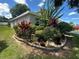 Well maintained front yard with flowering bushes around the perimeter of the home at 15509 Markham Dr, Clermont, FL 34714
