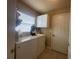 The laundry room includes a washer, dryer, storage cabinet and exterior access door at 15509 Markham Dr, Clermont, FL 34714
