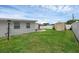 Well-maintained backyard features a storage shed, patio area and grassy lawn at 1025 Capella Dr, Tavares, FL 32778