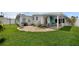 Expansive backyard with lush green grass and white home with covered patio at 1025 Capella Dr, Tavares, FL 32778