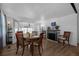 Dining room with wood floors, fireplace, ceiling fan, and doors leading to screened porch at 1025 Capella Dr, Tavares, FL 32778