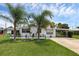 Well-maintained property with lush landscaping and charming nautical-themed decorations at 1025 Capella Dr, Tavares, FL 32778