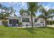 Charming home featuring a well-maintained lawn and decorative landscaping at 1025 Capella Dr, Tavares, FL 32778