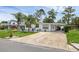 Charming single-story home with a well-manicured lawn and a long driveway at 1025 Capella Dr, Tavares, FL 32778