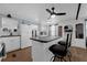 Bright kitchen with center island, barstool seating, appliances and white cabinetry at 1025 Capella Dr, Tavares, FL 32778