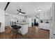 Open kitchen featuring a center island with seating and views into dining room and living room at 1025 Capella Dr, Tavares, FL 32778