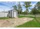 View of the backyard shed with access to a public road beyond the property's fenced perimeter at 1025 Capella Dr, Tavares, FL 32778