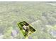 Aerial view showing the property highlighted with a yellow border, surrounded by a lush green landscape at 1053 Cavern Dr, Apopka, FL 32712