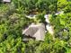Aerial view of the roof of the home, showcasing its proximity to a canopy of mature trees at 1053 Cavern Dr, Apopka, FL 32712