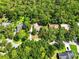 Aerial view of the property with mature trees, a long driveway and well-maintained landscaping at 1053 Cavern Dr, Apopka, FL 32712