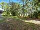 Large, grassy backyard with mature trees providing ample shade at 1053 Cavern Dr, Apopka, FL 32712