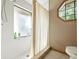 Bright bathroom features white tiled shower with glass door and unique octagon window at 1053 Cavern Dr, Apopka, FL 32712