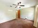 Bedroom with carpet, standard closet, ceiling fan, and a connecting door to another area at 1053 Cavern Dr, Apopka, FL 32712