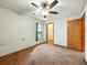 Bedroom with carpet, standard closet, ceiling fan, and a window providing natural light at 1053 Cavern Dr, Apopka, FL 32712