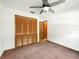 Neutral bedroom with carpet flooring, ceiling fan, and closet storage space at 1053 Cavern Dr, Apopka, FL 32712