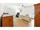 Bedroom with light wood floors, ceiling fan, and bright windows for natural light at 1053 Cavern Dr, Apopka, FL 32712