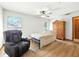 Bedroom featuring laminate floors, a ceiling fan, and a comfortable recliner chair at 1053 Cavern Dr, Apopka, FL 32712