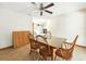Light-filled dining room featuring tile floors, a ceiling fan, and glass top wooden table at 1053 Cavern Dr, Apopka, FL 32712