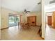 Dining room with tile flooring, ceiling fan, and view of the screened in back porch at 1053 Cavern Dr, Apopka, FL 32712