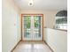 Entryway with tile flooring, a decorative arched window, and glass paneled french doors at 1053 Cavern Dr, Apopka, FL 32712