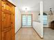 Bright foyer with tiled floor, white trim, and French doors leading outside at 1053 Cavern Dr, Apopka, FL 32712
