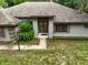 Inviting front entrance with double doors and well-maintained landscaping at 1053 Cavern Dr, Apopka, FL 32712